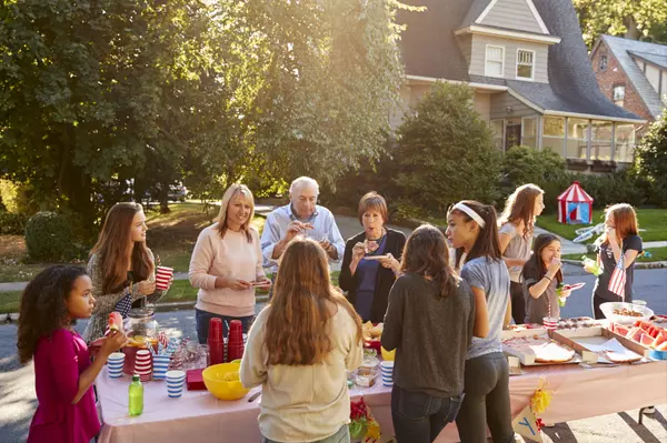 neighbours-talk-and-eat-around-a-table-at-a-block-2023-11-27-05-17-33-utc