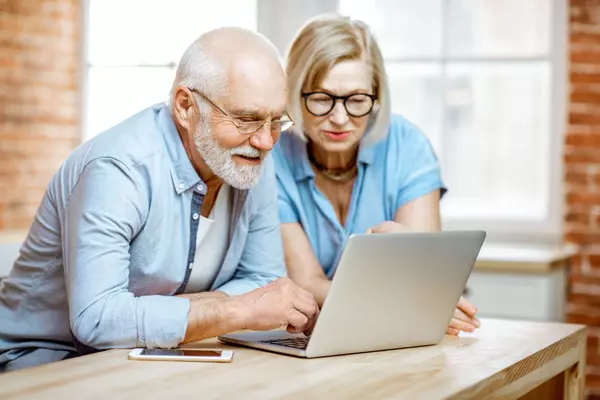 senior-couple-with-laptop-at-home-2022-01-19-00-03-36-utc (1)