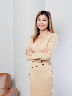 This image features Wendy Wei, a real estate agent with Monarch Realty Group in Atlanta, GA. Wendy is dressed in a stylish, light beige outfit that exudes professionalism and elegance. Her long, straight hair is a soft brown with subtle highlights, and she wears it down, framing her face beautifully. She has a warm, friendly smile that adds to her approachable and confident demeanor.  Her pose is poised and professional, standing with arms crossed, conveying a sense of confidence and readiness. The background is minimalistic with neutral tones, allowing Wendy to be the central focus of the image. The setting complements her polished appearance, making her look both approachable and capable, which is ideal for someone in the real estate industry.