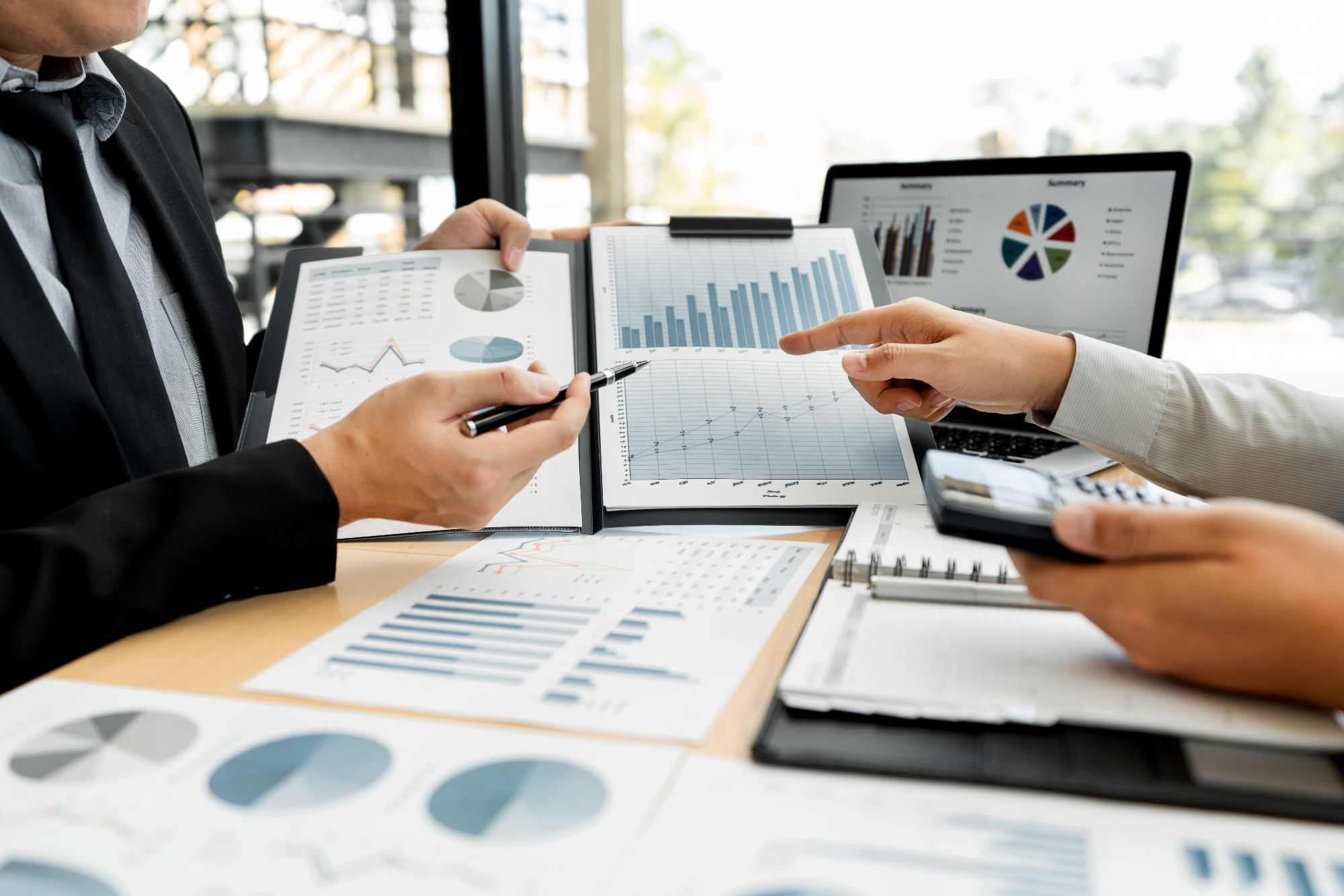 Business Corporate team brainstorming, Planning Strategy having a discussion Analysis investment researching with chart at office his desk documents and saving concept (1)