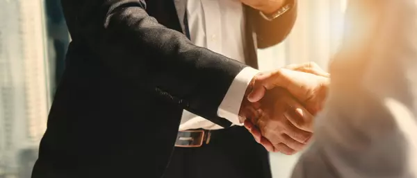 businessman handshake for teamwork of business merger and acquisition (1)