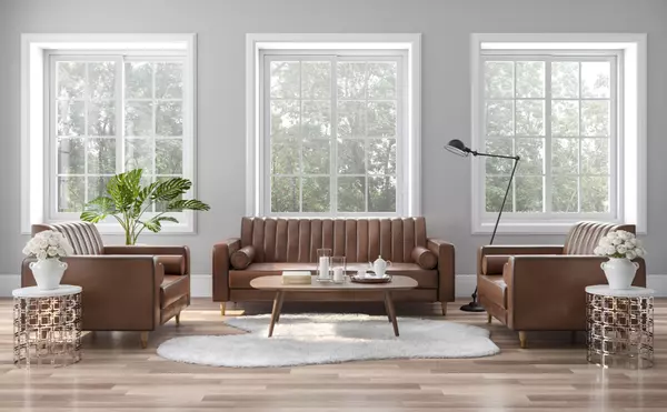 The vintage style living room is decorated with brown-orange leather sofas