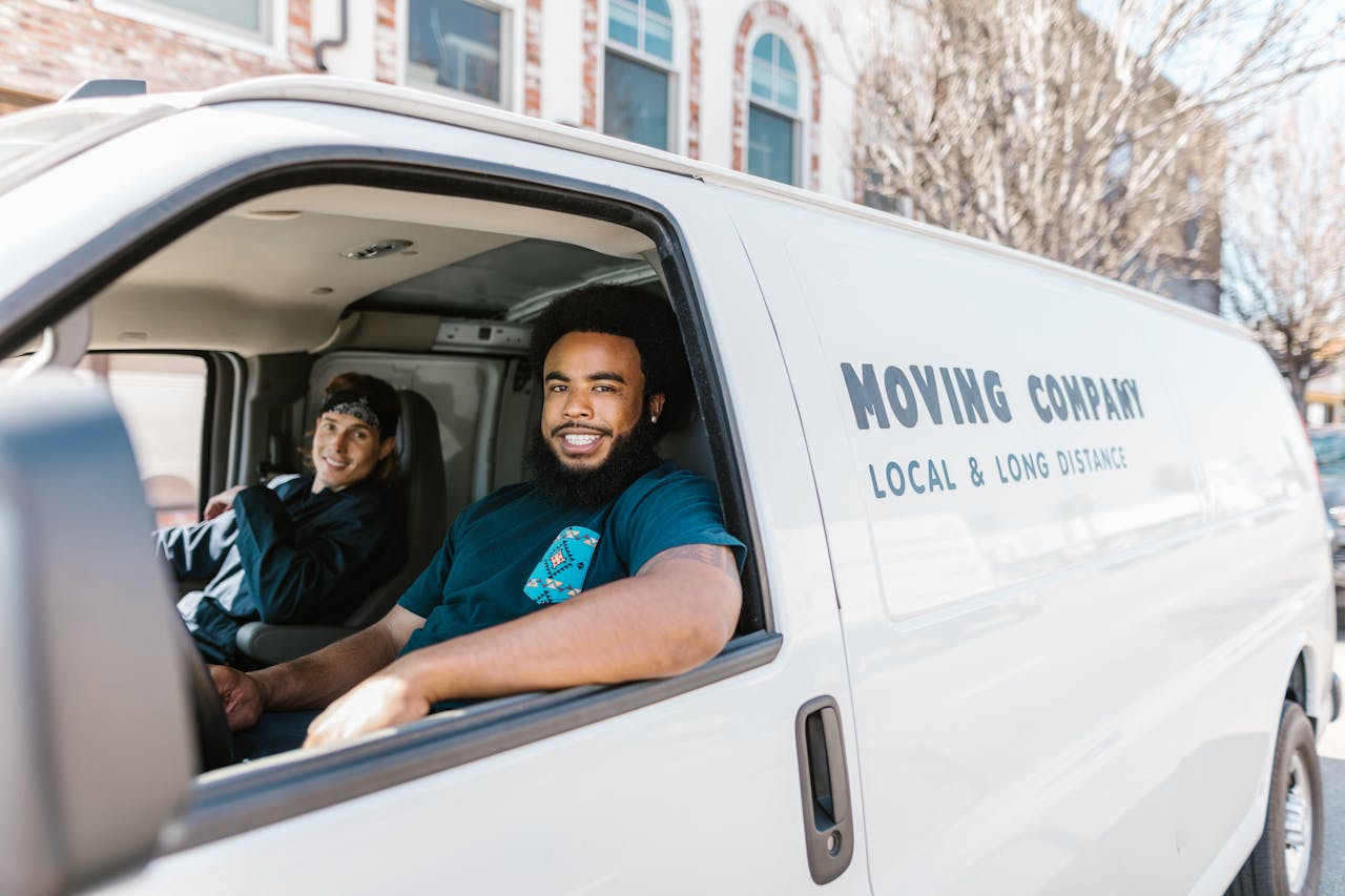 Two people in a moving company van