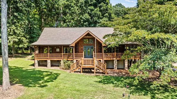 Log cabin home with wrap around porch 1055 Mount Zion Church Rd