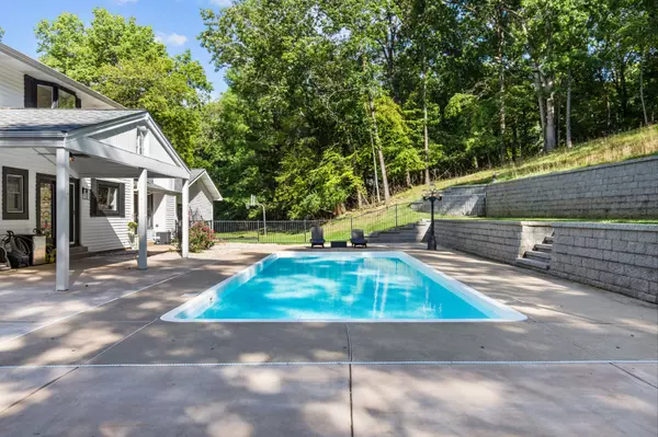 large luxury pool in st louis home with forest in the backyard