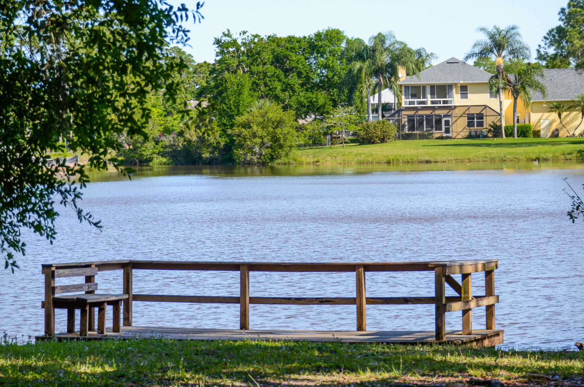 View of Fawn Lake and a spacious home from a wooden observation deck