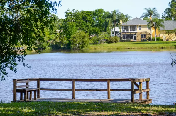 View of Fawn Lake and a spacious home from a wooden observation deck