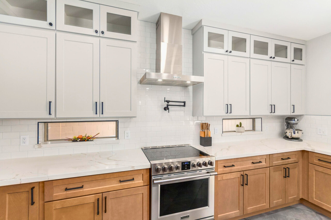 Modern updated kitchen featuring new countertops, sleek cabinetry, stylish backsplash, and stainless steel appliances in a spacious Augusta Ranch home in Mesa, AZ.