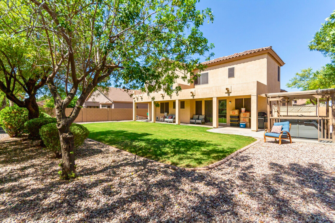 Spacious backyard in Augusta Ranch home featuring a well-maintained lawn with ample room for a pool or outdoor entertainment area, offering potential for future enhancements such as an ADU.