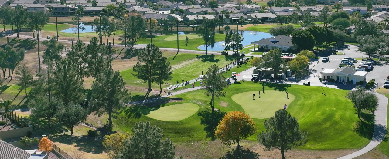 Arial view of Augusta Ranch Golf Course in Mesa, AZ, showcasing lush green fairways, surrounding homes, and the scenic layout of Arizona's top-rated executive golf course.