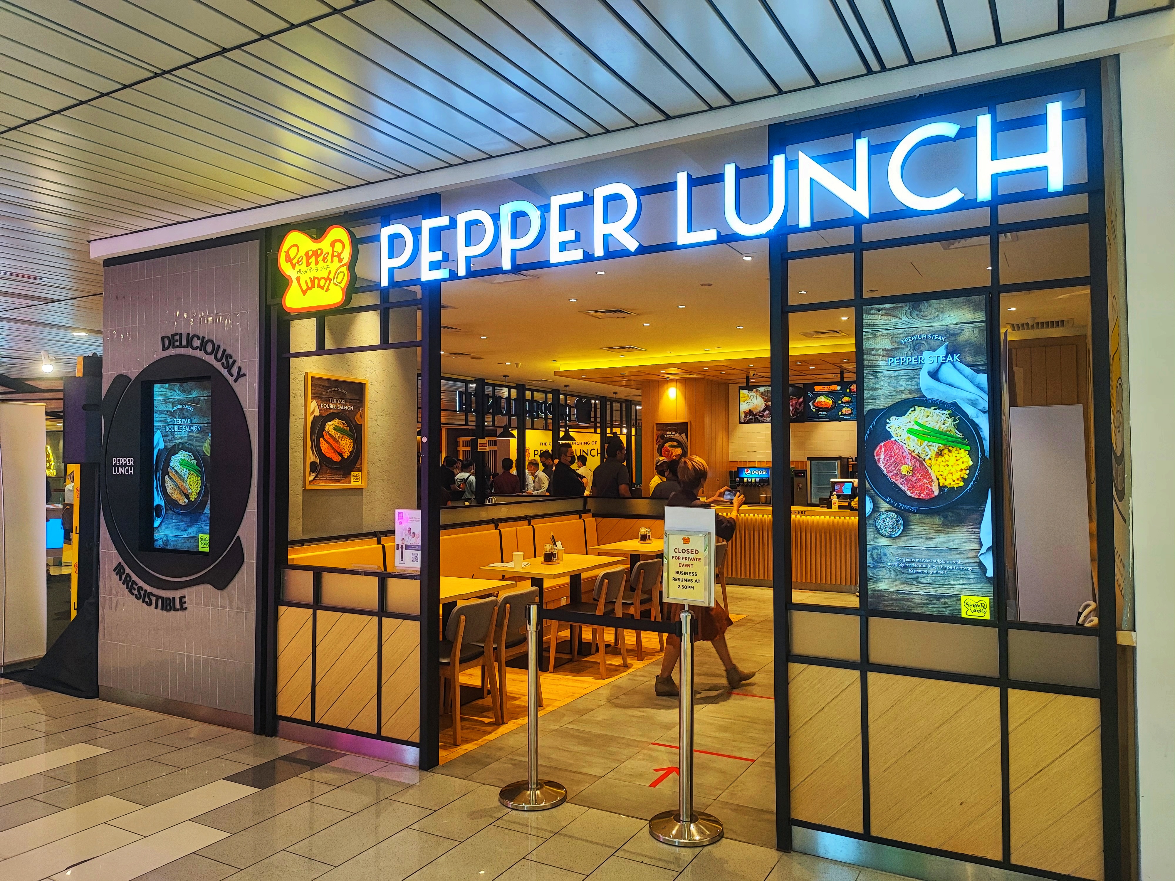 Exterior of Pepper Lunch restaurant at Arizona State University, marking its first U.S. franchise. The building features modern signage and a welcoming storefront, with plans for expansion across Phoenix.