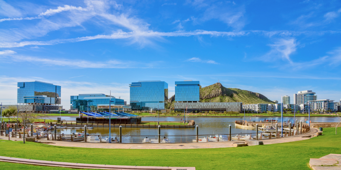 Stunning view of Tempe Town Lake in Phoenix Metro, showcasing modern office buildings, lush green spaces, and scenic waterfront amenities. Phoenix offers a thriving job market, booming industries like semiconductor manufacturing and healthcare innovation, and a resilient housing market with diverse options. With year-round sunshine, outdoor recreation, and a lower cost of living compared to other metros, Phoenix is an ideal destination for relocation and investment in 2025. Want to learn more about why Phoenix is the place to be? Let's chat!