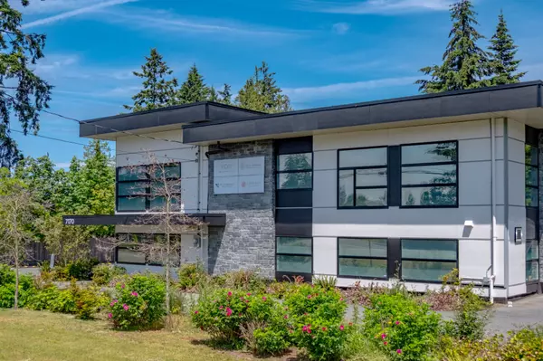 Modern commercial building in Lantzville, BC, surrounded by greenery and blue skies. A key business hub on Vancouver Island, showcasing contemporary architecture and community development.