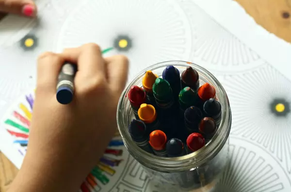 Kids in school colouring in a book