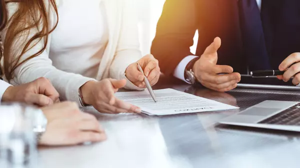 Business people discussing contract while working together in sunny modern office (2)