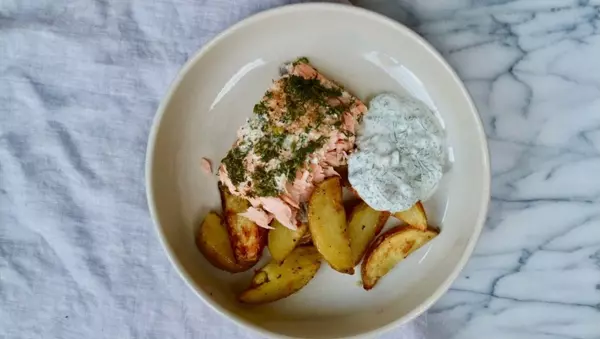 Dill salmon with potato wedges and a creamy pickle and dill sauce