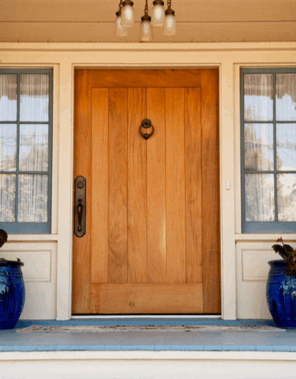 Rustic wood door with flower pots on a front porch, southern style