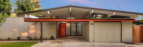 Classic Silicon Valley Eichler exterior with post-and-beam roofline and orange door