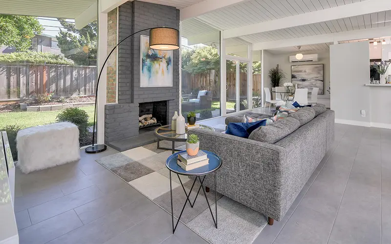Eichler living room with walls of glass, staged for sale