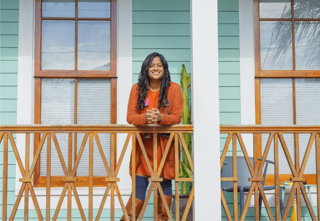 Woman Looking for Homes for Sale in New Orleans and Drinking Coffee While Wrapped in a Blanket | Reve Realtors